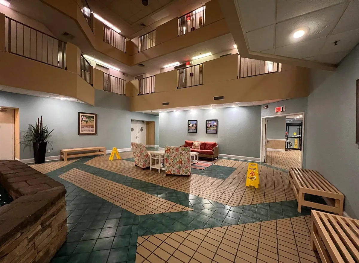A colorful seating area filled with vibrant chairs and a lively indoor plant, set against decorative wall art. The setup suggests a social, casual environment perfect for group gatherings and informal hangouts before heading out on the town.